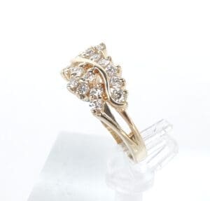 Gold ring with multiple diamond clusters.
