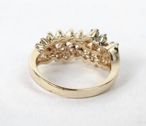 Gold ring with intricate crown design.