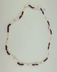 Red and white beaded necklace on display.
