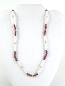Red and white beaded necklace on display.