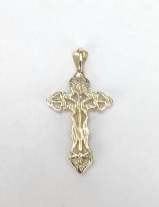 Gold cross pendant on white background.