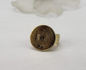 Gold ring with engraved markings.