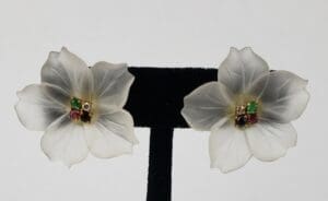 White flower earrings with colorful gemstones.