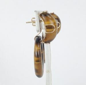 Brown hoop earrings on white background.