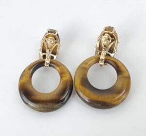 Brown hoop earrings with gold details.