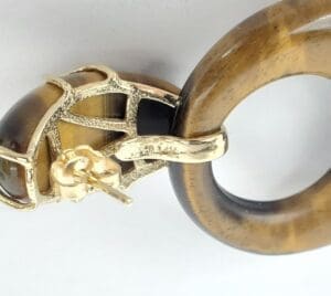 Gold and brown round earring close-up.