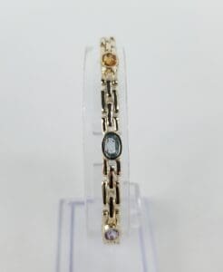 Gold bracelet with colorful gemstones.