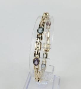 Gold bracelet with colorful gemstone accents.