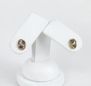 Gold and blue gemstone stud earrings.
