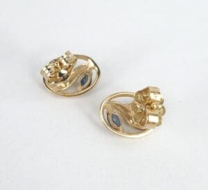 Gold rings with blue gemstone accents.