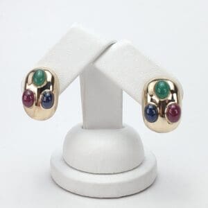 Gold earrings with colorful gemstone accents.