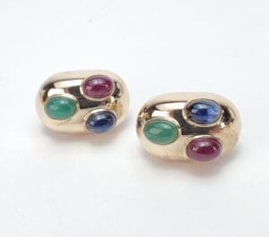 Gold earrings with colorful gemstone accents.