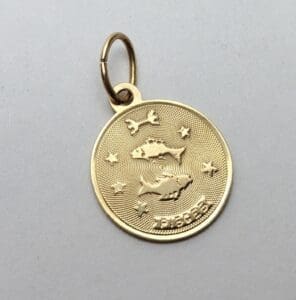 Gold Pisces pendant with fish design.