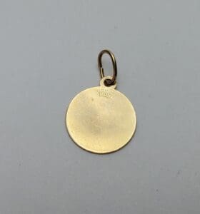 Gold circular pendant with a loop attachment.