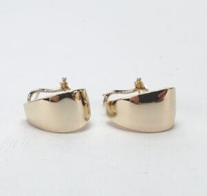 Gold hoop earrings on white background.