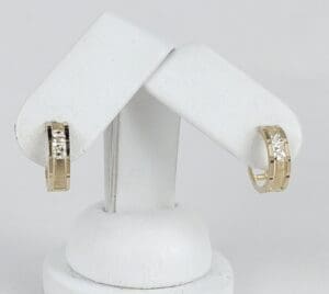 Gold hoop earrings with square diamonds.