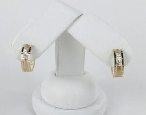 Gold hoop earrings with diamond accents displayed.