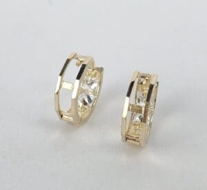 Gold hoop earrings with geometric design.