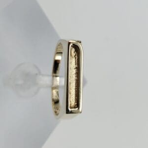 Gold ring with rectangular design detail.