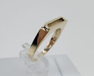 Gold ring with modern geometric design.