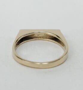 Gold ring with flat top design.