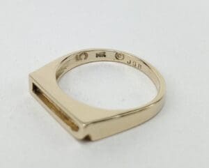 Gold ring with engravings on the band.