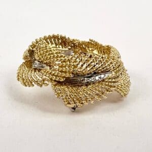 Gold twisted ring with textured design.