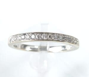 Silver ring with small embedded diamonds.
