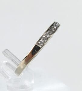 Gold ring with embedded diamonds on display.