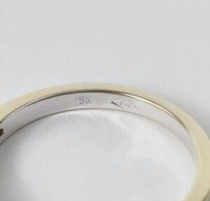18K gold ring with engraved markings.