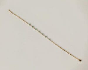 Gold chain bracelet with turquoise stones.