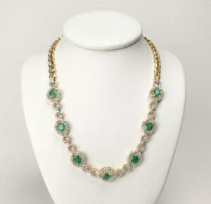 Gold necklace with green gemstone accents.