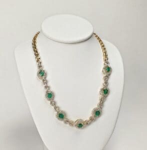 Gold necklace with green gemstone accents.