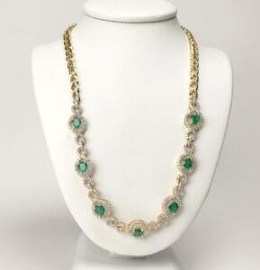 Gold necklace with green gemstone accents.