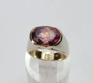 Gold ring with large red gemstone.
