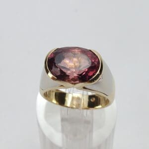 Gold ring with large red gemstone.