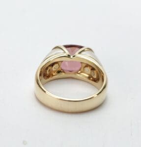 Gold ring with pink gemstone setting.