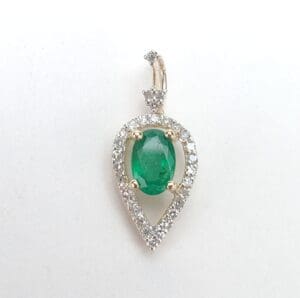 Teardrop emerald pendant with diamond accents.