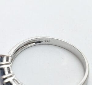 Close-up of a silver ring with hallmark.