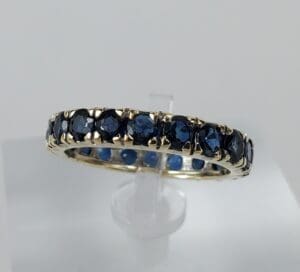 Gold ring with dark blue gemstones.