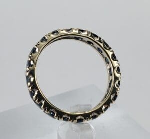 Gold ring with black textured accents.