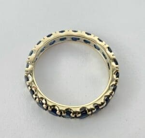 Gold ring with blue gemstone accents.