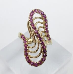 Gold ring with pink gemstone design.