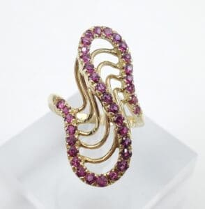 Gold ring with purple gemstone accents.
