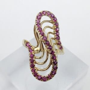 Gold ring with pink gemstone design.