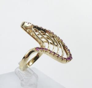 Gold ring with pink gemstone accents.