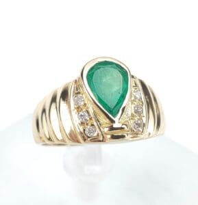 Gold ring with emerald and diamonds.