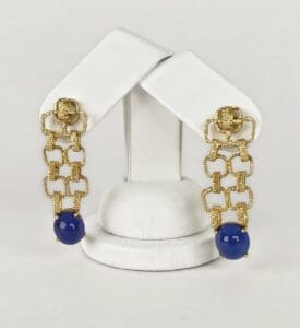 Gold chain earrings with blue beads displayed.