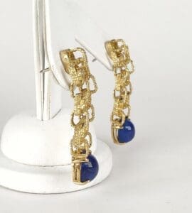 Gold chain earrings with blue stones.