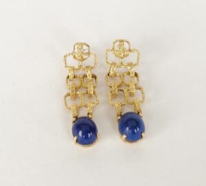 Gold earrings with blue stone accents.
